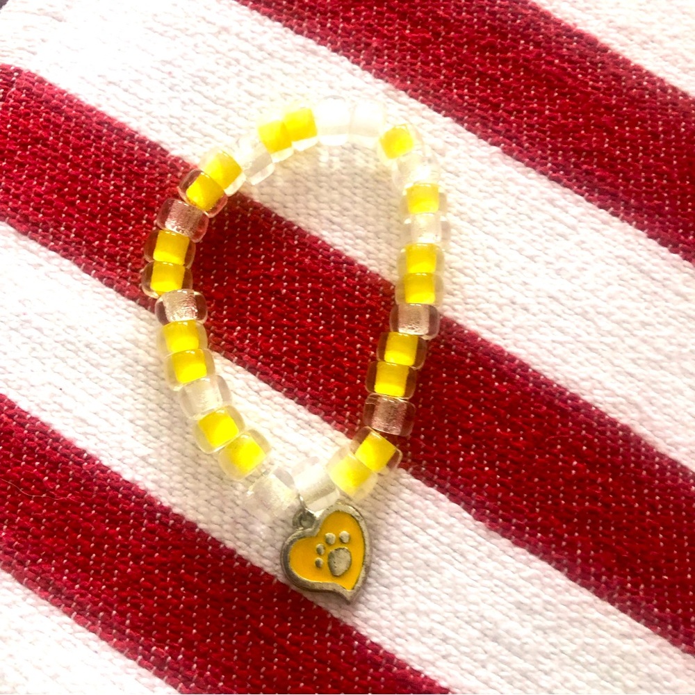 Cute yellow and white bracelet with yellow heart with paw print in it